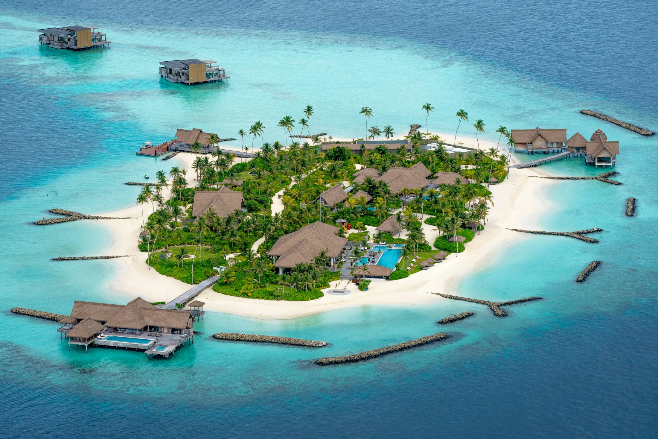 An island retreat in turquoise Maldivian waters, used as illustrative architectural photography