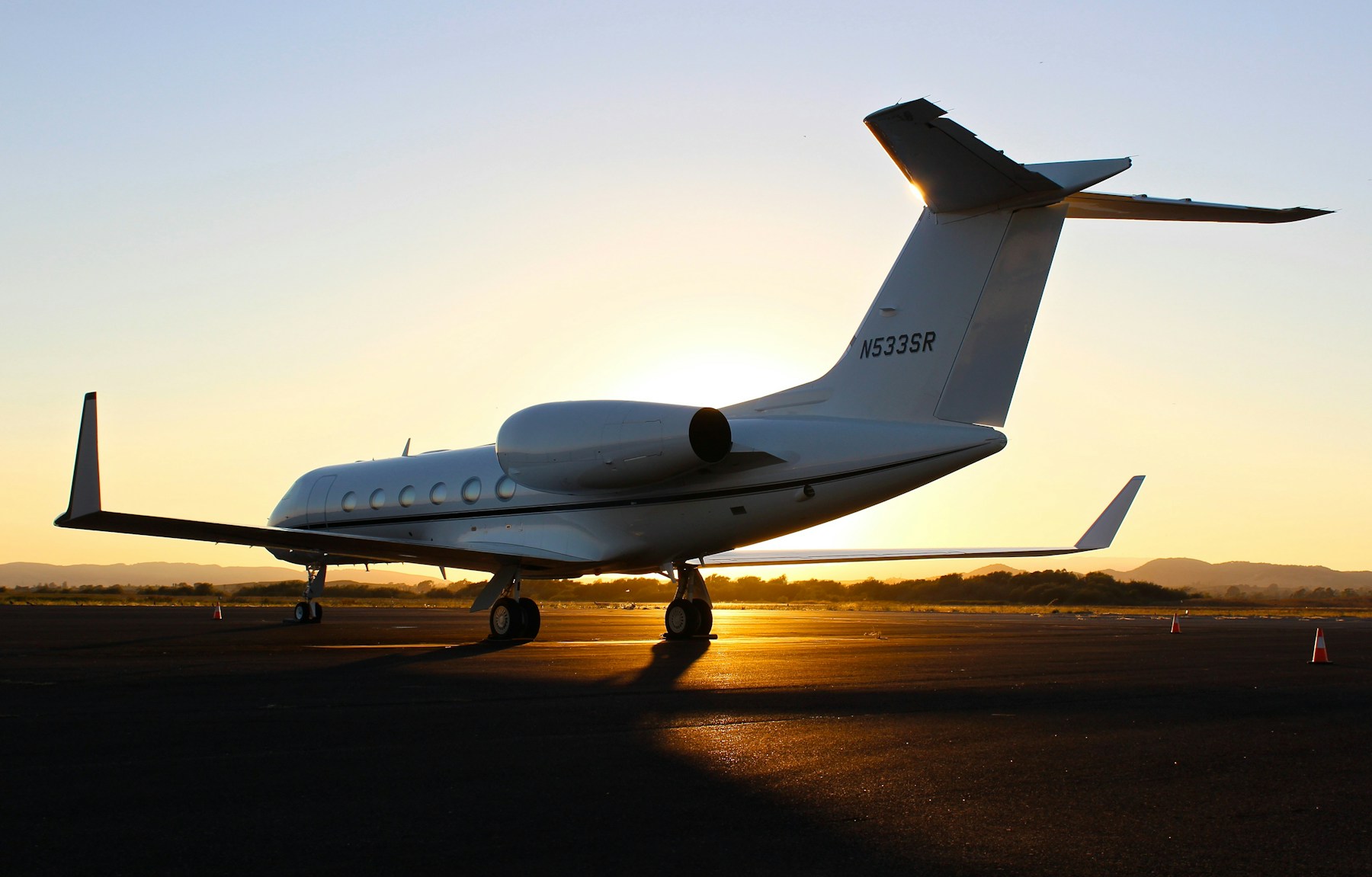 A private jet on the tarmac at sunset